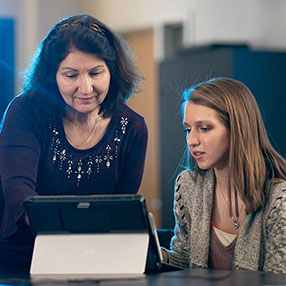 A Student and Advisor Looking at a Computer.